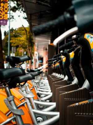 A row of parked bicycles on a city street showcasing urban transportation solutions.