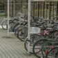 Bicycles parked in an outdoor urban lot in Wrocław, Poland.
